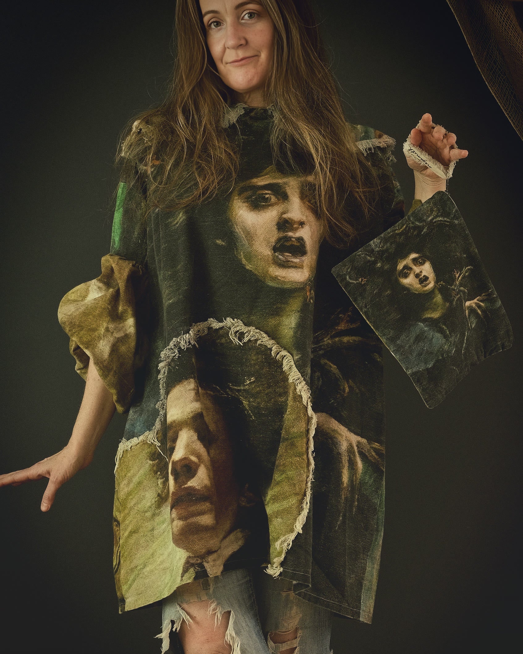 woman wearing a cotton linen dress with bold 19th century artwork print and holding a matching fabric clutch